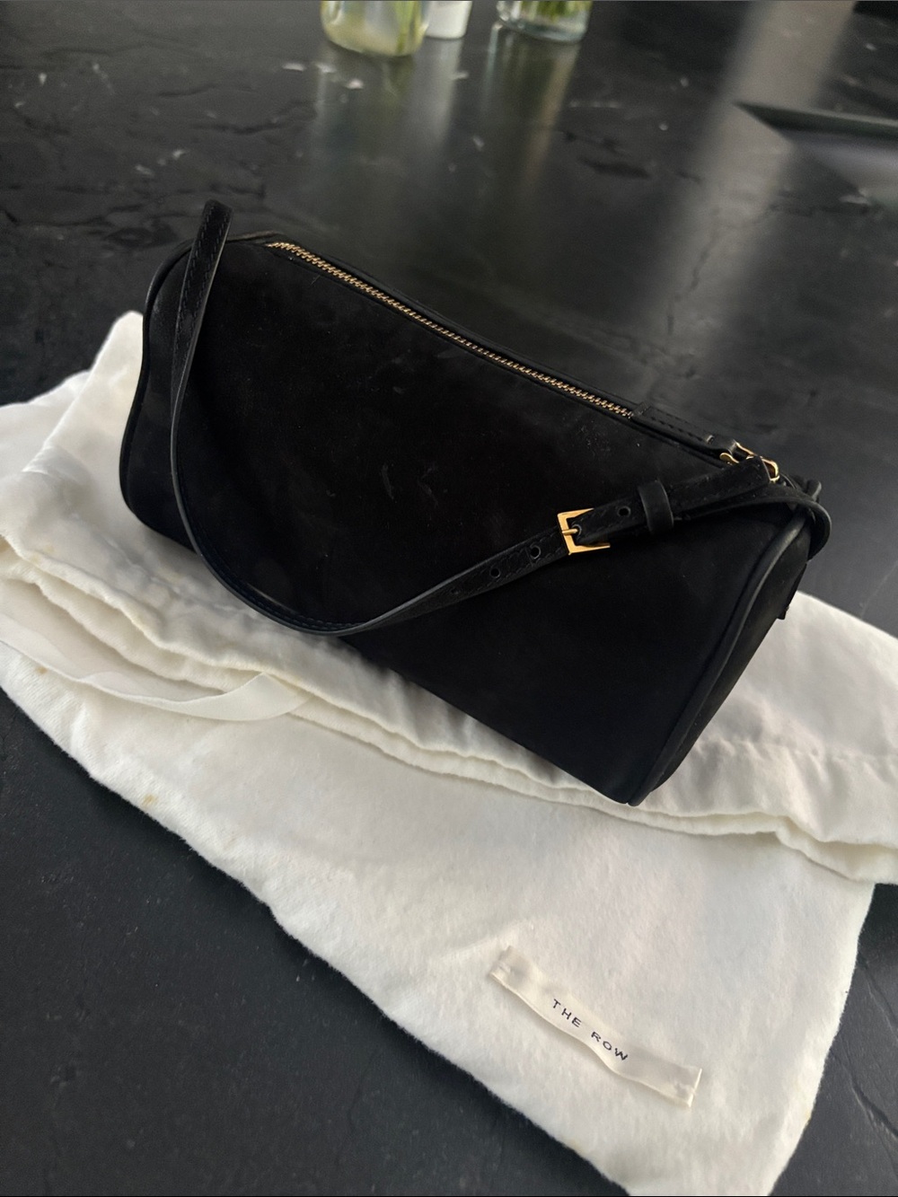 The Row 90’s bag in black suede